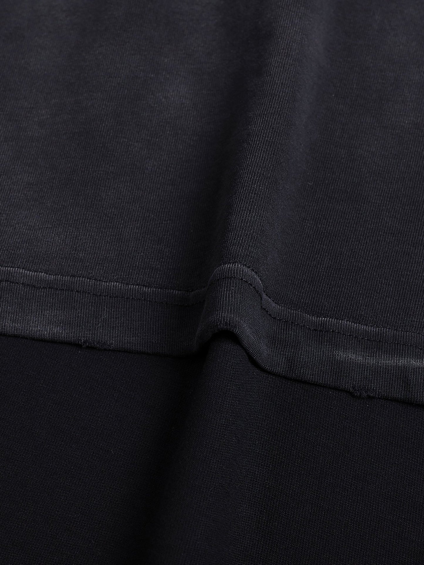 Bleed Electric Let The Invasion Begin black cotton t-shirt fabric close up showing vintage wash texture and raw edge finish