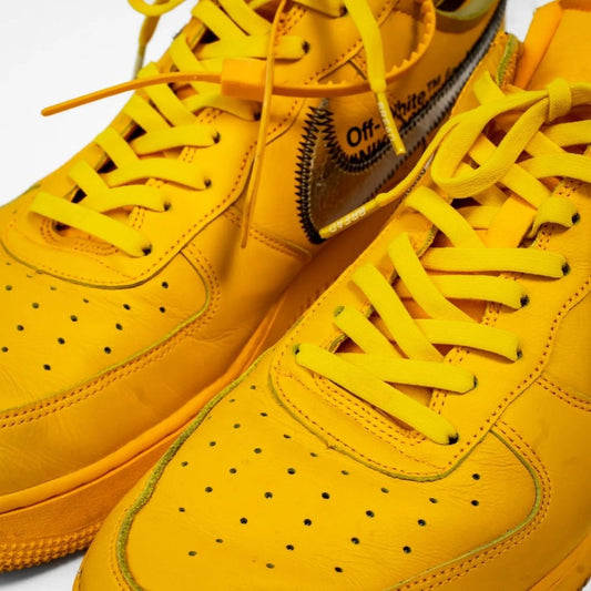 Close-up of Bread Corona Yellow elastic laces installed on yellow Nike sneakers