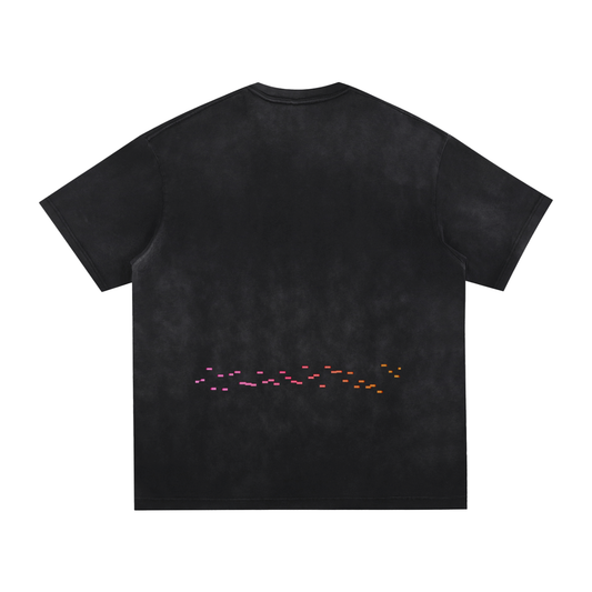 Back of black washed oversized t-shirt featuring abstract editing timeline in pink and orange