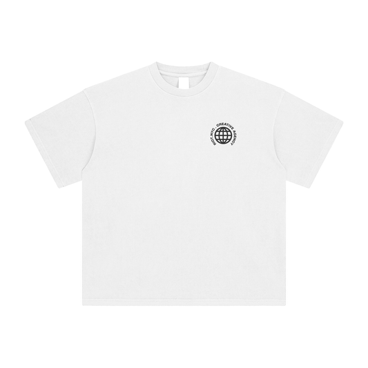 Front chest detail of white t-shirt with black globe logo and "RIOT NYC. CREATIVE SIGNAL" text – minimalist design