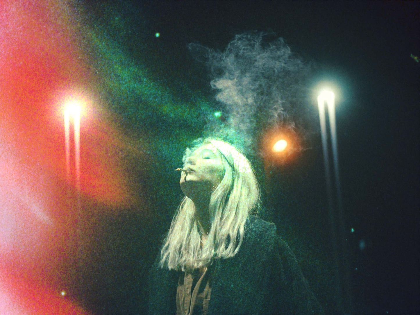 analog film texture overlay example showing distorted film grain and light leak effects at night