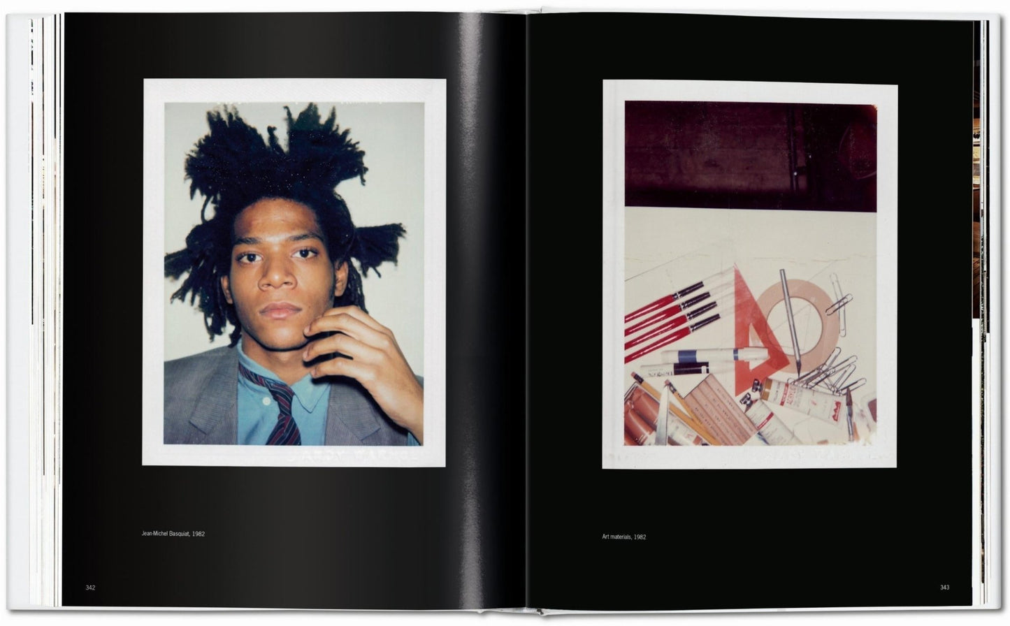 Interior spread from the Andy Warhol Polaroids TASCHEN book showing a left Polaroid portrait of Jean-Michel Basquiat in a jacket and tie and a right Polaroid still life of art materials including brushes, pens, rulers, and tubes of paint