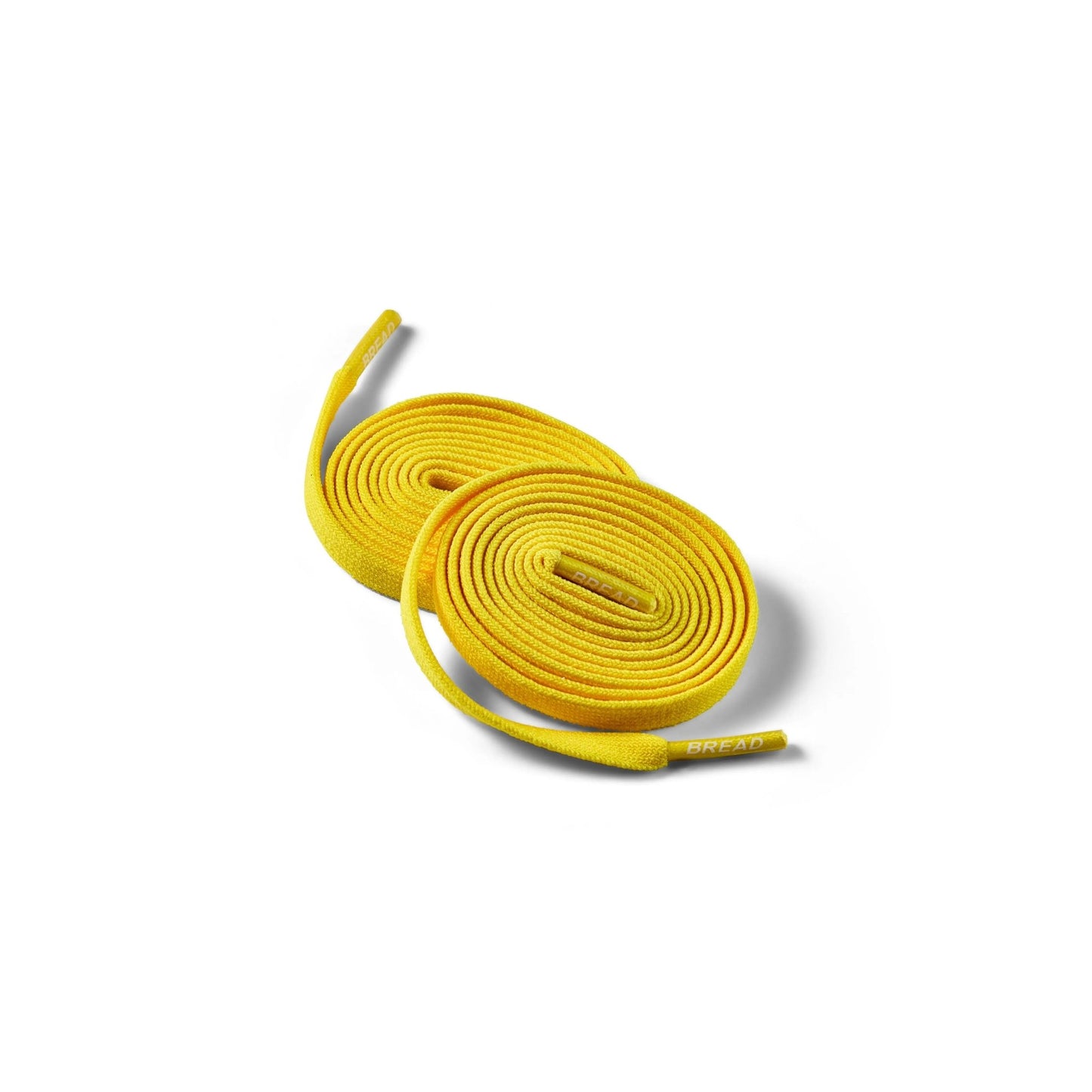 Bread Corona Yellow elastic shoelaces coiled on white background with branded aglets