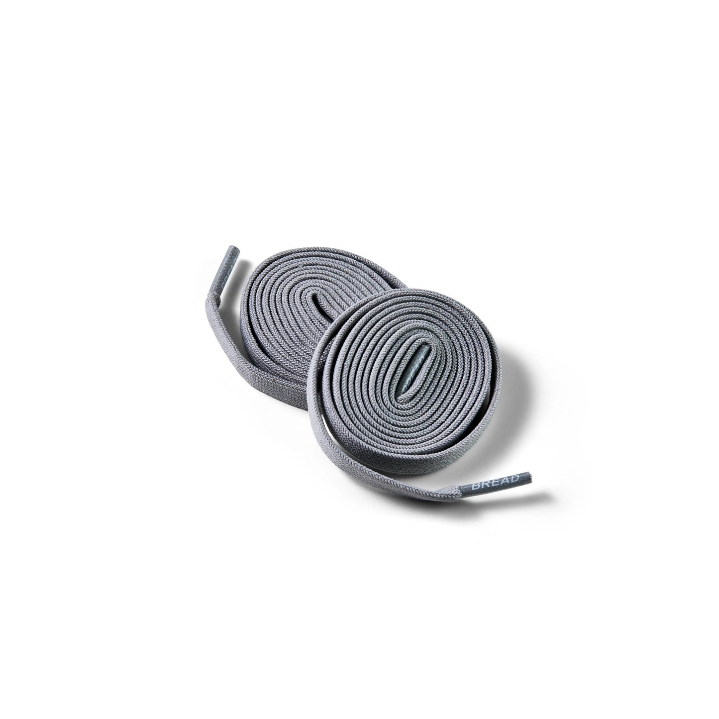 Bread Elastic Shoelaces in Vulture Gray rolled flat with branded aglets visible