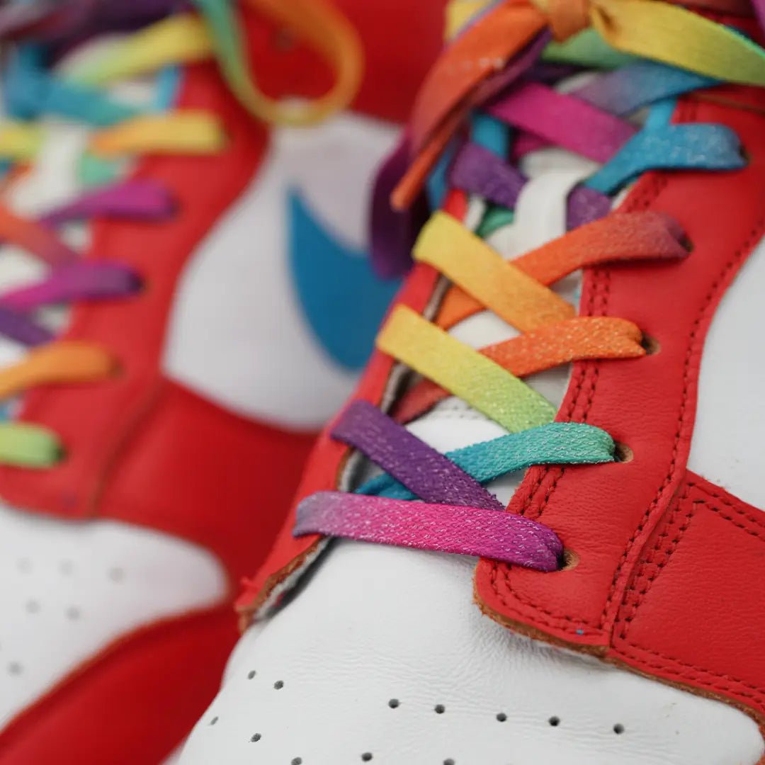 Close-up of Bread Rainbow elastic shoelaces styled on red and white sneakers