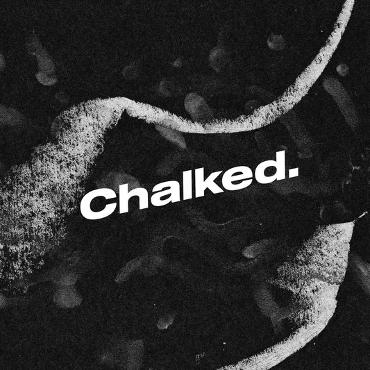 Chalked logo over gritty black background with abstract chalk streaks and dust textures