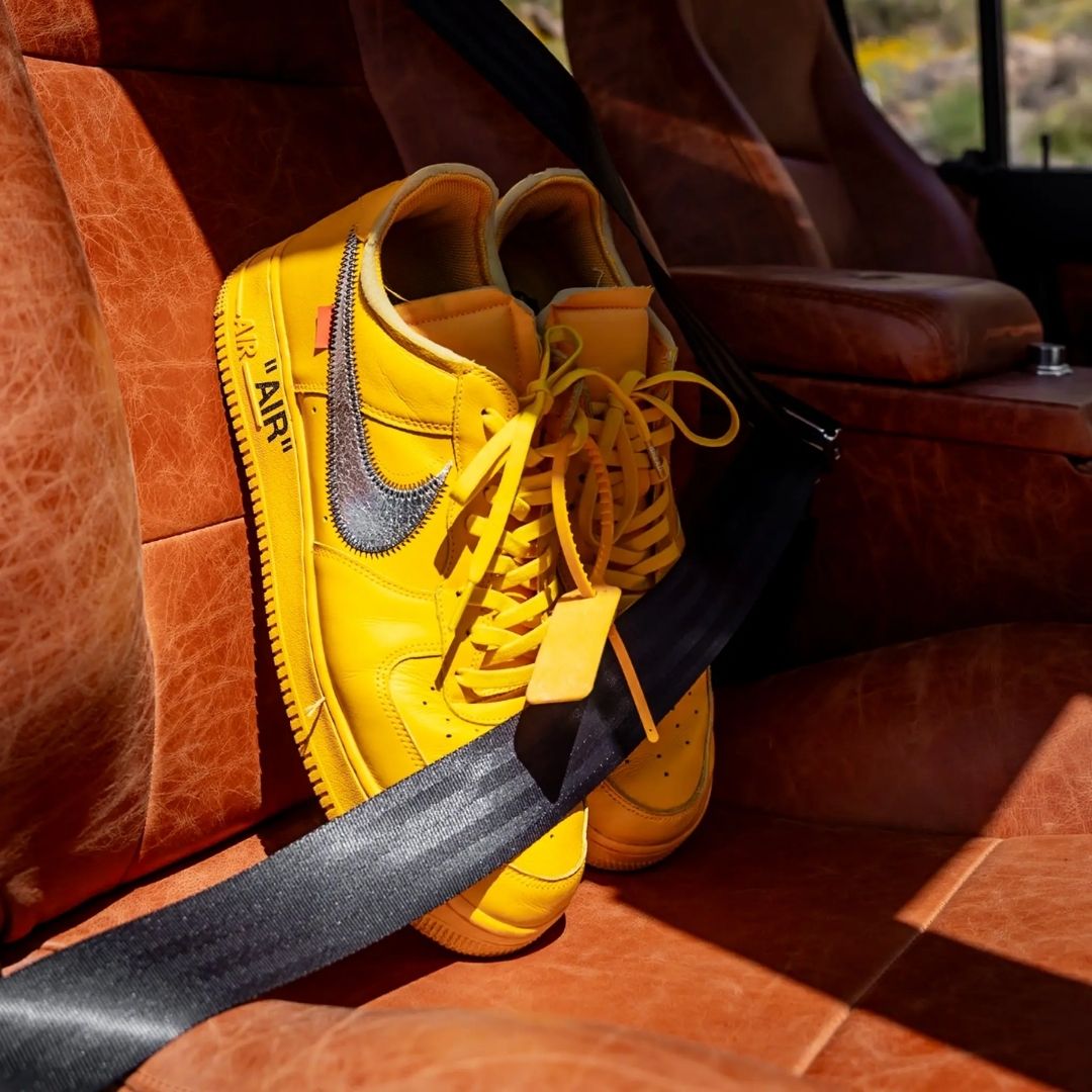Yellow sneakers with Bread Corona Yellow stretch laces secured in leather car seat