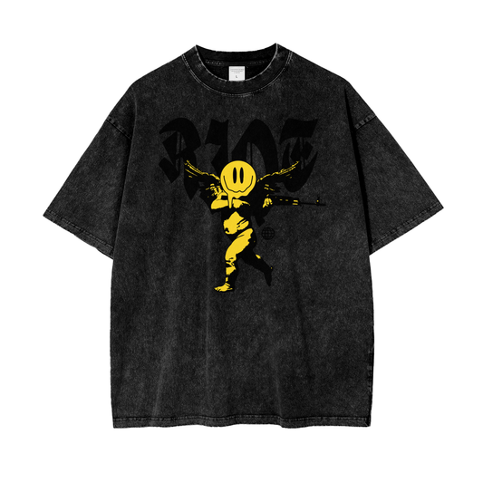 Front of black snow-washed oversized t-shirt featuring smiley cherub graphic and RIOT lettering