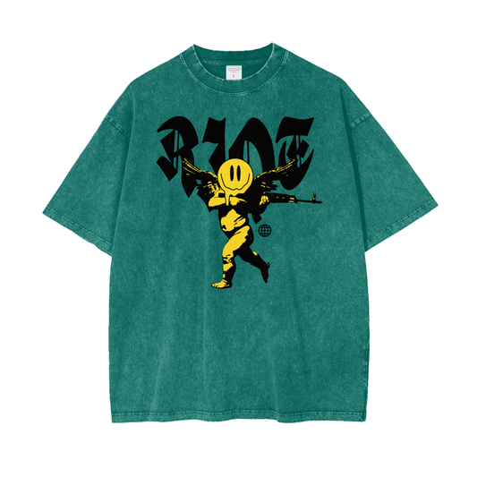Front of dark green snow-washed oversized t-shirt featuring smiley cherub graphic and RIOT lettering
