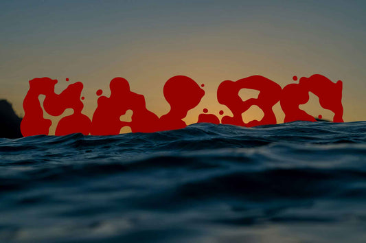 Malbo Typeface in red ink style floating above ocean waves at sunset