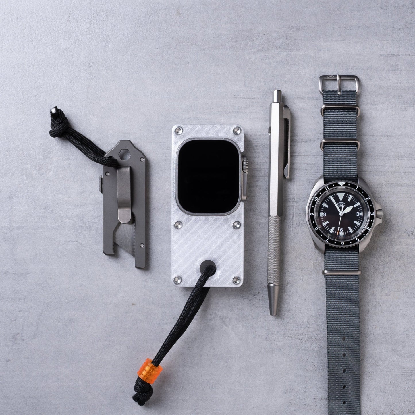 miniphone ultra ghost white Apple Watch Ultra case flat lay with everyday carry tools and watch