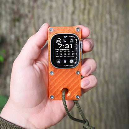 hand holding orange miniphone ultra Apple Watch Ultra case outdoors