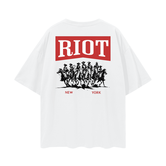 Back of lucent white oversized t-shirt featuring seven cowboys riding beneath red RIOT banner with “New York” below