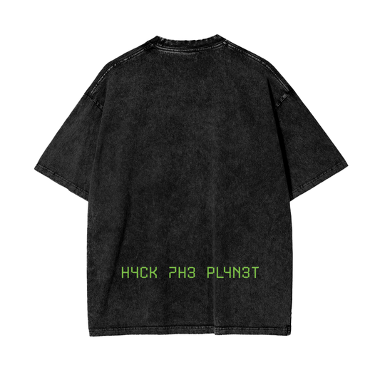 Back of black acid-wash t-shirt with green pixel text reading "H4CK 7H3 PL4N3T"