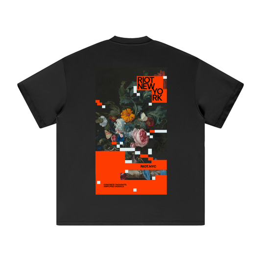 Black tee back with RIOT NEW YORK poster: glitched floral still life, white pixel blocks, bold orange panels, and RIOT.NYC bar.