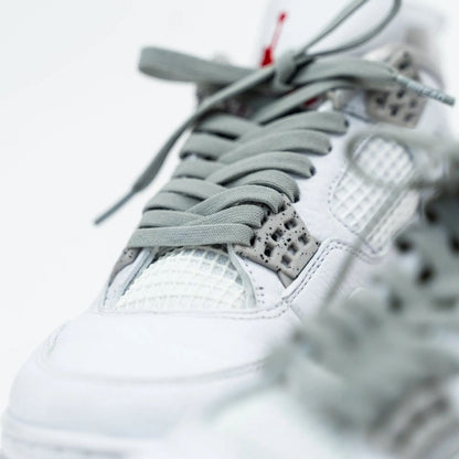 Close-up detail of Bread Vulture Gray laces threaded through white sneaker eyelets
