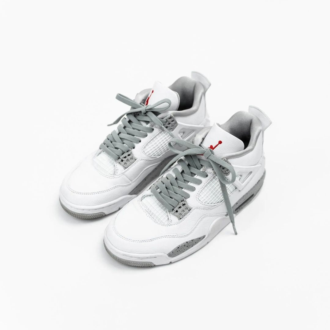 White Jordan 4 sneakers styled with Bread Vulture Gray elastic shoelaces
